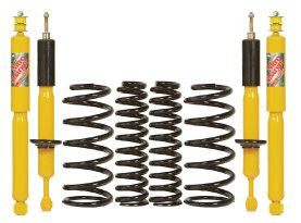 Yellow shock absorbers and black coil springs for 2.5-3 inch lift suspension kit, designed for FJ Cruiser heavy load.