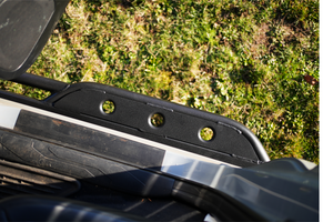 Close-up of black Metal Tech 4x4 rock slider with three circular holes installed on 2016 Tacoma short bed 4-door truck.