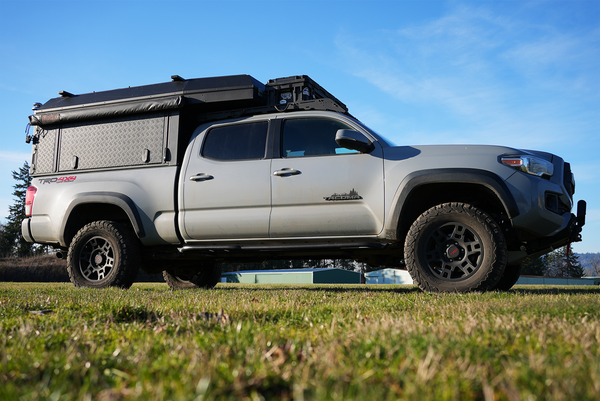 Side view of 2016 Toyota Tacoma 4-door with Metal Tech 4x4 rock sliders installed on short bed.