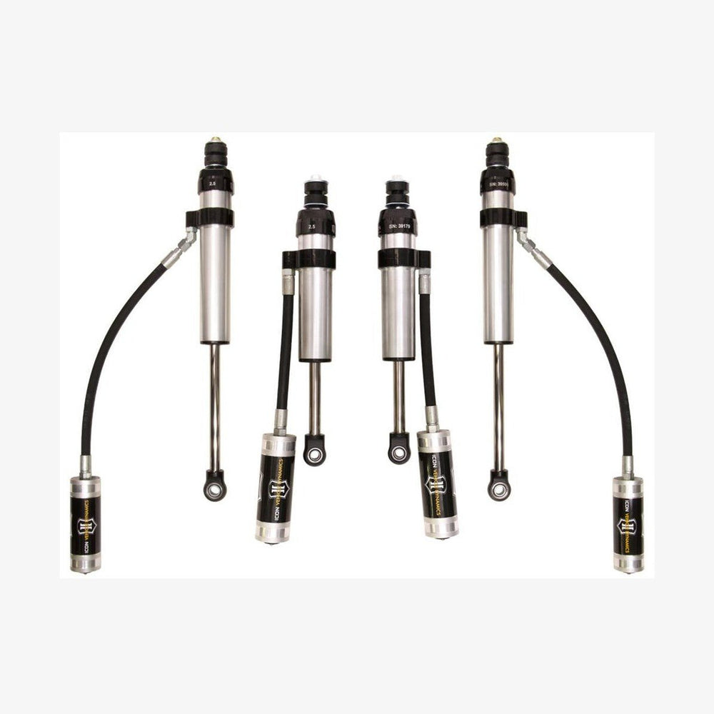 Set of four silver and black performance shock absorbers with remote reservoirs for Toyota Land Cruiser 100 Series and Lexus LX470.