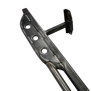 Close-up of raw steel Metal Tech 4x4 rock slider with three circular cutouts and welded mounting bracket.