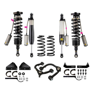 Complete suspension kit for 200 Series Land Cruiser with coil springs, shock absorbers, control arms, and mounting hardware.