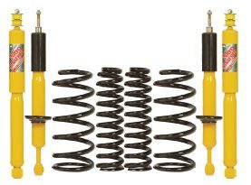 Yellow shock absorbers and black coil springs for 2.5–3 inch lift suspension kit, compatible with FJ Cruiser.
