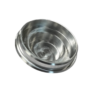 Close-up of a CNC milled billet metal pivot cap with concentric circular grooves and a smooth finish.