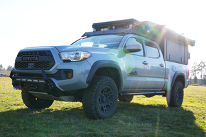 2016 Toyota Tacoma with Metal Tech 4x4 rock sliders installed on short bed, 4-door truck in outdoor setting.