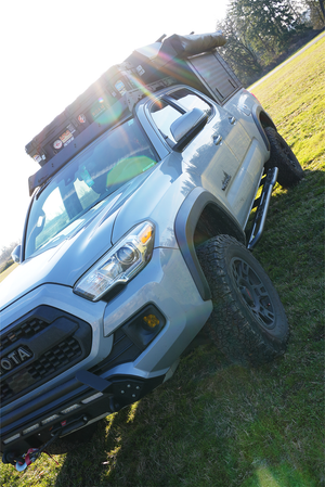 Front angled view of 2016 Tacoma with Metal Tech 4x4 rock sliders installed on short bed, 4-door truck.