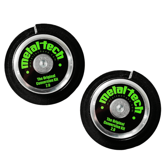 Pair of black and silver Metal Tech rear coil conversion kit components with green logo and text on white background.