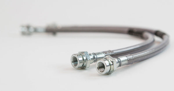 Close-up of two metal extended rear brake lines with threaded fittings for Lexus GX470 and GX460.