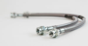 Close-up of two metal extended rear brake lines with threaded fittings for FJ Cruiser and 4Runner.