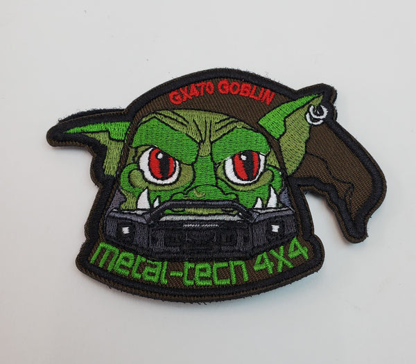 Close-up of embroidered Metal Tech 4x4 patch featuring a green goblin with red eyes and brown headscarf.