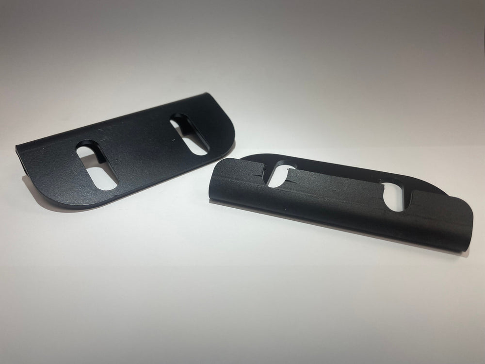 Pair of black metal tube door striker plates with oval mounting slots, shown on white background.