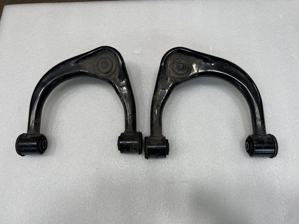 Pair of black upper control arms for GX470, GX460, FJ Cruiser, and 4th-5th gen 4Runner on white background.