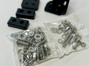 Two clear plastic bags filled with silver screws, nuts, and washers for landing pad system assembly.