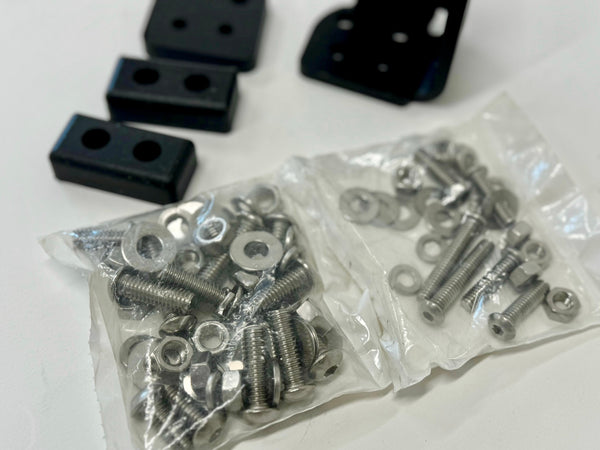 Two clear plastic bags filled with silver screws, nuts, and washers for landing pad system assembly.