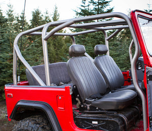 Full-profile metal roll cage installed inside red FJ40 Land Cruiser with black front and rear seats visible.