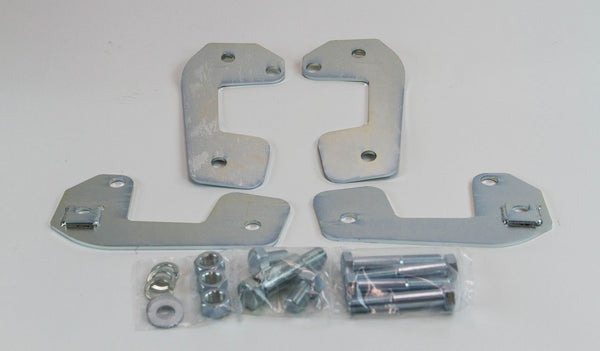 Raw steel caster correction plates with mounting bolts, nuts, and washers for FJ80 Land Cruiser suspension adjustment.
