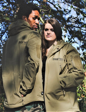Two models outdoors wearing olive green Metal Tech 20th Anniversary tactical jackets with logo and zippered pockets visible.