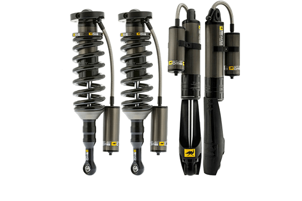 Set of four black OME GX470 GX460 BP 51 3 Heavy Kit shocks with remote reservoirs, front coilovers and rear shocks shown side by side.