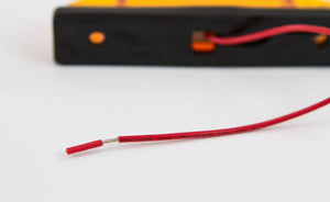 Close-up of red electrical wire attached to amber LED step light for GX470 and GX460 rear bumpers.
