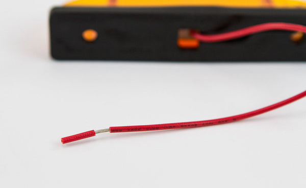 Close-up of red electrical wire attached to amber LED step light for GX470 and GX460 rear bumpers.