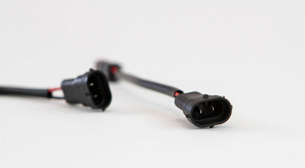 Close-up of black OEM-style fog light harness connectors for 2010 Toyota 4Runner, Tundra, and Tacoma.
