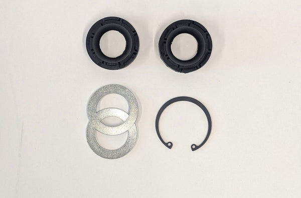 Lower link flex joint rebuild kit showing two black rubber seals, two metal washers, and one black retaining ring on white background.