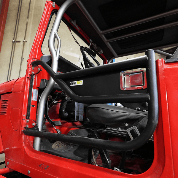 Close-up of black Metal Tech tube door installed on red FJ40 Land Cruiser interior side.
