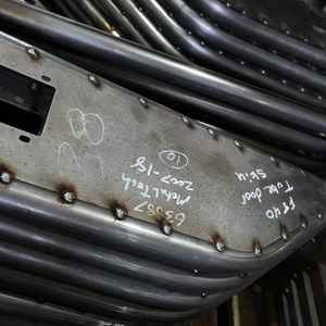 Close-up of welded metal tube door frame with handwritten markings for Metal Tech FJ45 Land Cruiser.