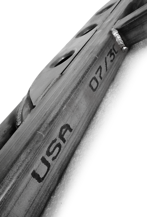 Close-up of welded metal frame with "USA" and "07/30" markings on 2010 4Runner trail rock slider.