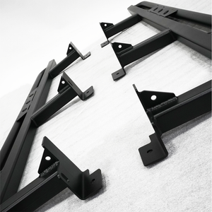 Close-up of black metal rock sliders with mounting brackets for 2016 Tacoma 4-door long bed installation.