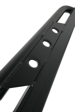 Close-up of black steel trail rock slider with welded mounting holes for 2010 4Runner off-road protection.