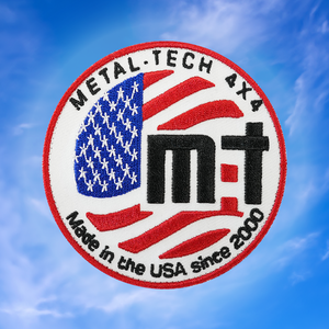 Round embroidered patch with American flag, "Metal Tech 4x4," and "Made in the USA since 2000" text on white background.