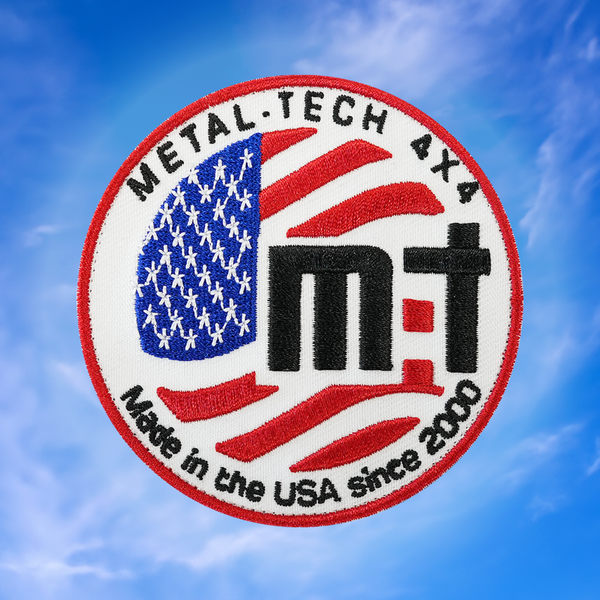 Round embroidered patch with American flag, "Metal Tech 4x4," and "Made in the USA since 2000" text on white background.