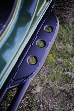 Close-up of black metal Sidewinder RRR rock slider with circular cutouts installed on 2021 Ford Bronco 2-door.