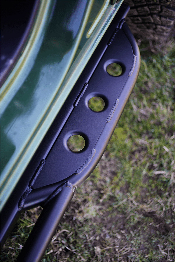 Close-up of black metal Sidewinder RRR rock slider with circular cutouts installed on 2021 Ford Bronco 2-door.