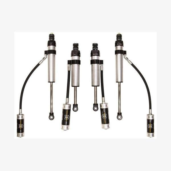 Set of four silver and black performance shock absorbers with remote reservoirs for Toyota Land Cruiser 100 Series and Lexus LX470.