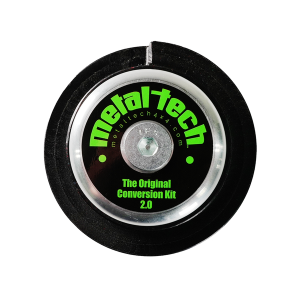 Close-up of Metal Tech GX460 rear coil conversion kit Stage 2 key cone with black and silver finish and green logo.