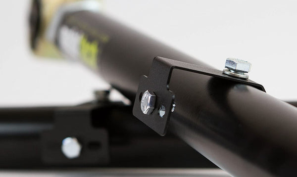 Close-up of black offset rear lower link with mounting bracket and bolts for 200 Series Land Cruiser LX570 suspension.