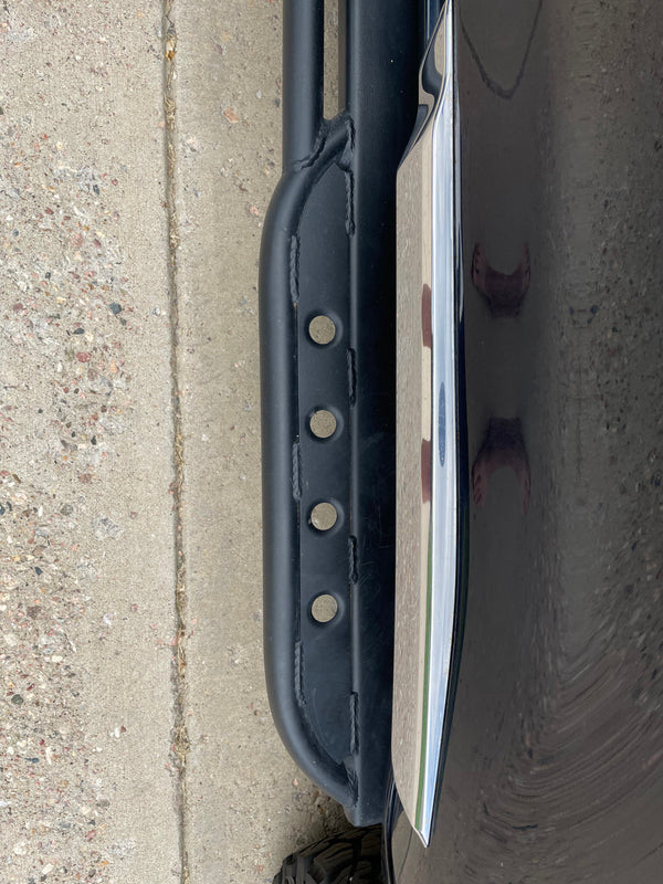 Close-up of black Metal Tech rock slider with mounting holes installed on 2008-2021 Toyota Land Cruiser side.