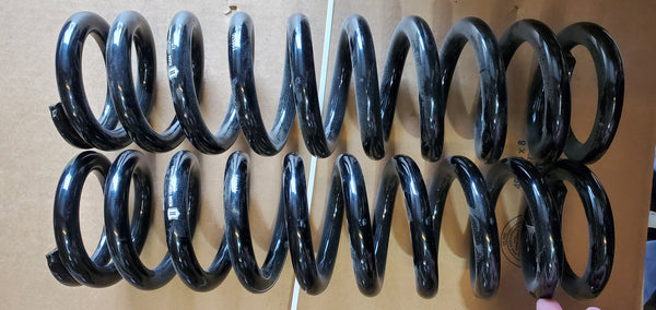 Pair of black 600lb coil springs for 2003-2019 Toyota 4Runner, shown side by side on cardboard background.