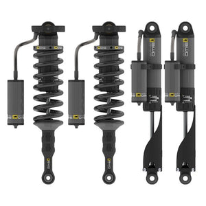 Set of four black OME GX470 GX460 BP 51 3 Heavy Kit shocks with remote reservoirs, front coilovers and rear shocks shown side by side.