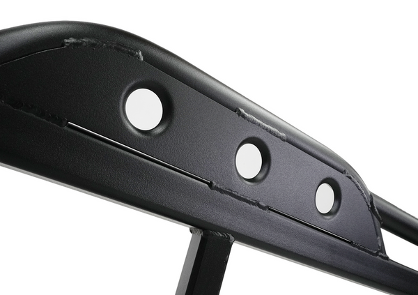 Close-up of black powder-coated steel rock slider with three circular cutouts and visible welds.