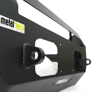 Close-up of black Metal Tech Fortress front bumper showing welded tow hooks and textured finish.