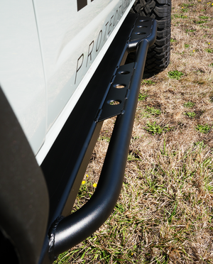Close-up of black metal rock slider installed on 2021 Ford Bronco 4-door, showing weld details and mounting points.