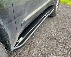 Black Metal Tech 4x4 rock slider installed on the side of a Lexus LX570, shown on gravel surface.