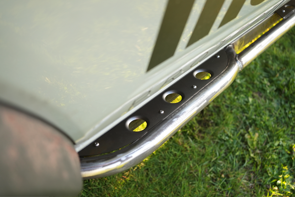 Close-up of stainless steel Sidewinder rock slider installed on 2021 Bronco 4-door, showing mounting details.