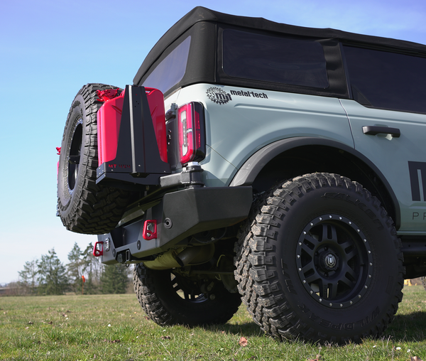 Rear view of a Ford Bronco 6G with Metal Tech 4x4 high rear bumper and mounted spare tire and fuel can.