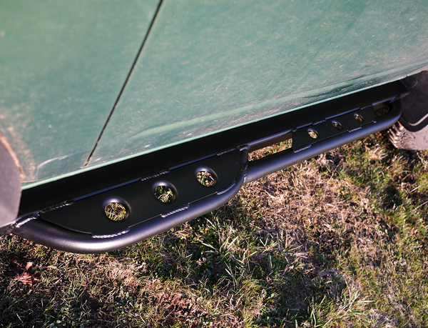 Close-up of black Sidewinder RRR rock slider installed on 2021 Ford Bronco 2-door, showing welded mounting points.