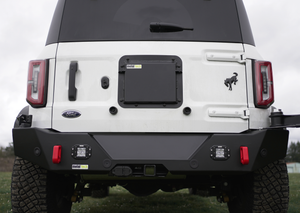 Rear view of white Ford Bronco 6G with black Metal Tech 4x4 high rear bumper and red tow hooks installed.