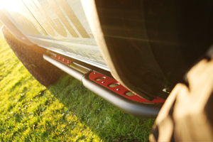 Close-up of black and red Sidewinder rock sliders installed on the side of a 2021 Bronco 4-door.